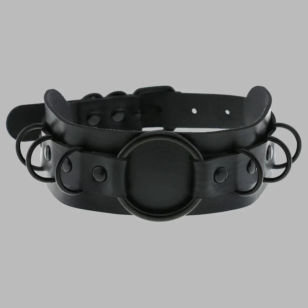 Wide black gothic collar featuring multiple O-ring details, matte black hardware, adjustable fit, and a bold layered design for alternative fashion, cosplay, and statement styling.