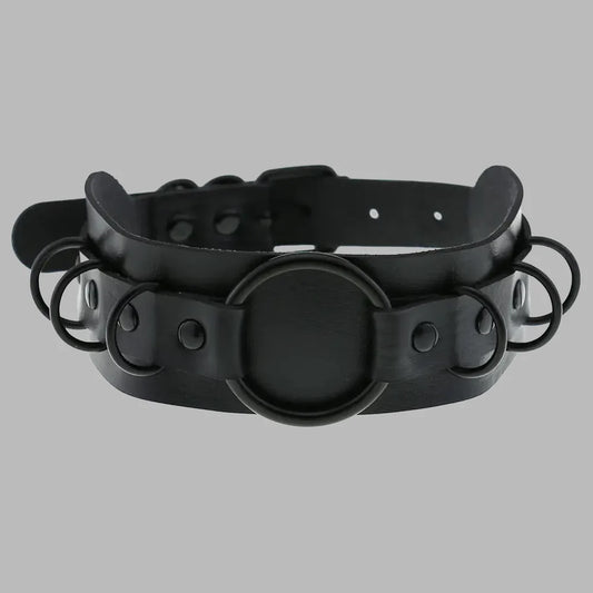 Wide black gothic collar featuring multiple O-ring details, matte black hardware, adjustable fit, and a bold layered design for alternative fashion, cosplay, and statement styling.